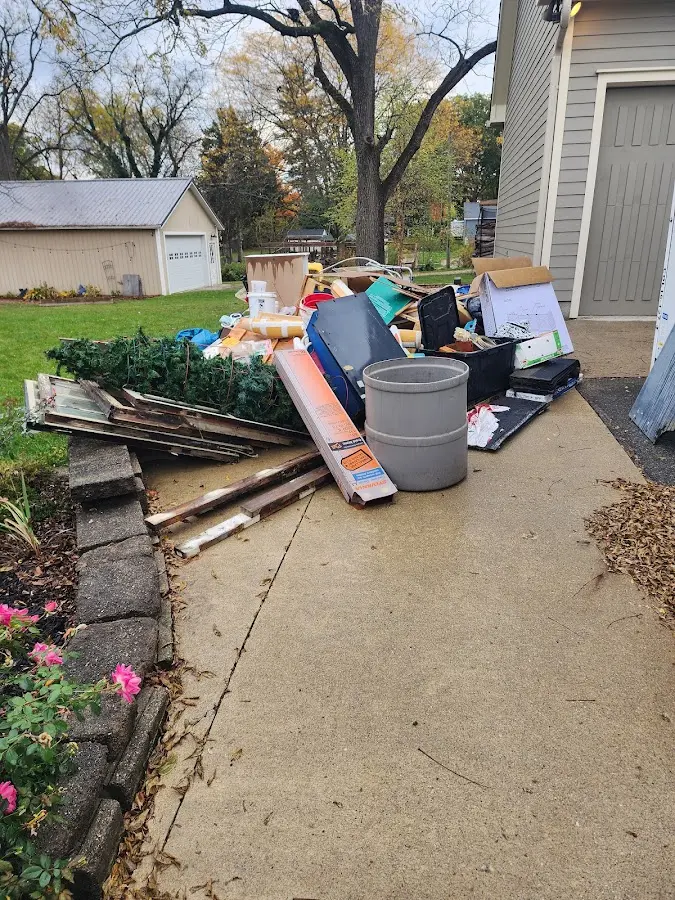 Dumpster being loaded with debris for Estate Cleanout Dumpster Rental in Burnham